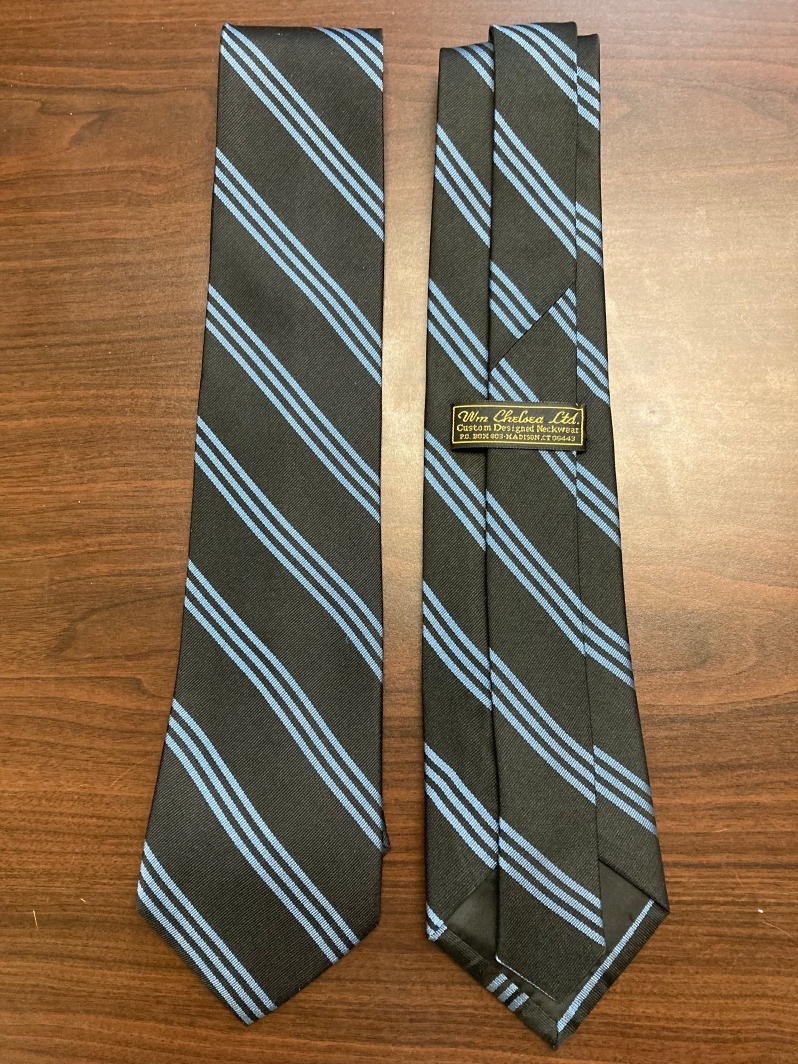 Product Description: Enjoy the luxury of the traditional Delta Phi Brotherhood Necktie, hand finished using the finest 100% silk and displaying the conservative "3 stripe" motif in traditional sky blue on a dark navy background that has been in use in the Fraternity for over 100 years. Perfect for business or casual wear, and a must have for any Delta Phi wardrobe.</br></br>Domestic Shipping included.</br></br>Contact Delta Phi National if you wish to ship internationally.</br> Delta Phi Brothers' Necktie